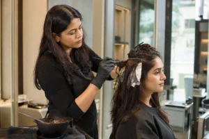 Professional hair colour application at a salon in Vile Parle East