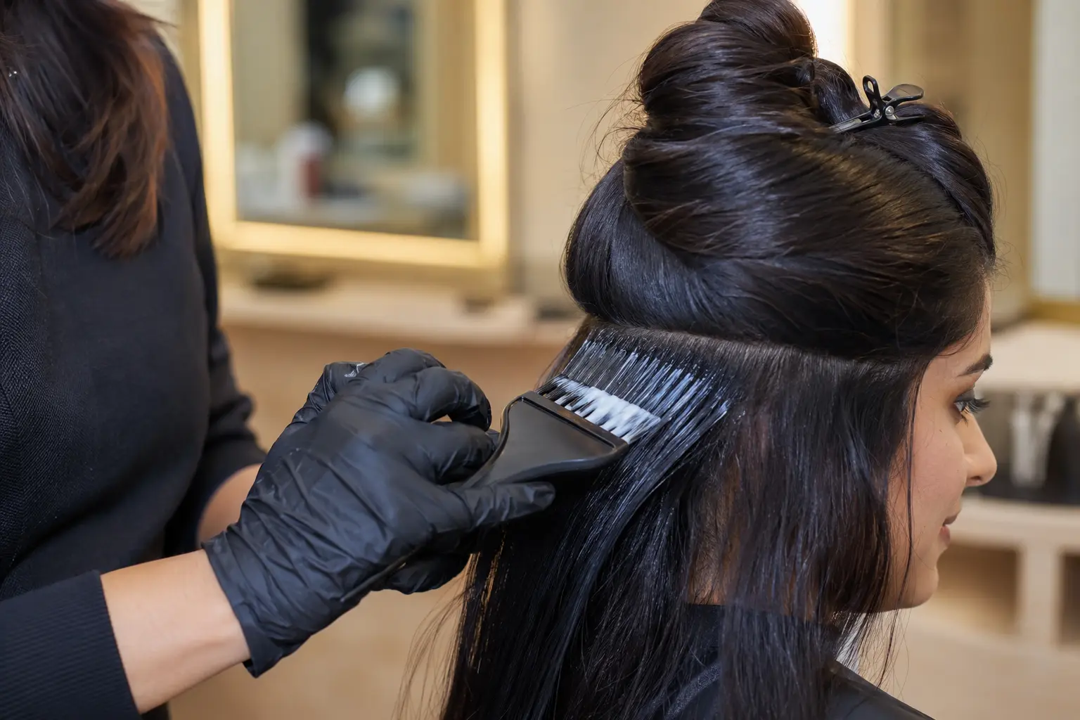 Keratin hair smoothing and blow-drying process at a professional salon